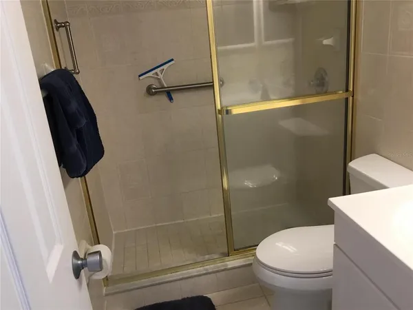 a bathroom with a toilet and a shower
