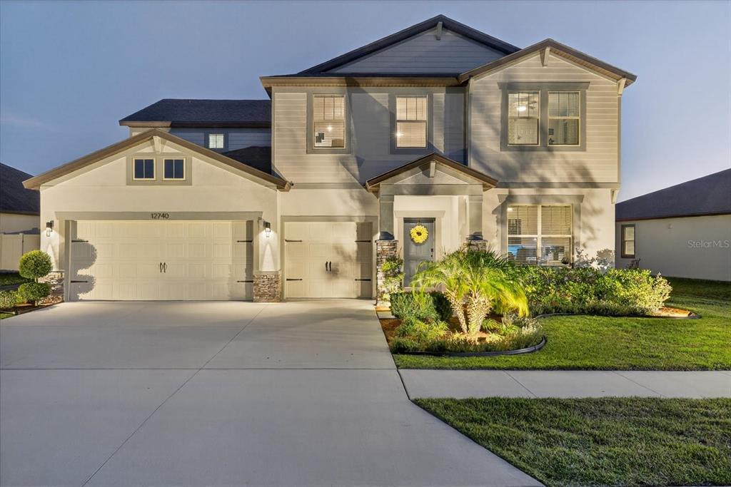 12740 Palapa Loop Spring Hill, FL 34610 - Photo 12 of 68 a front view of a house with a garden