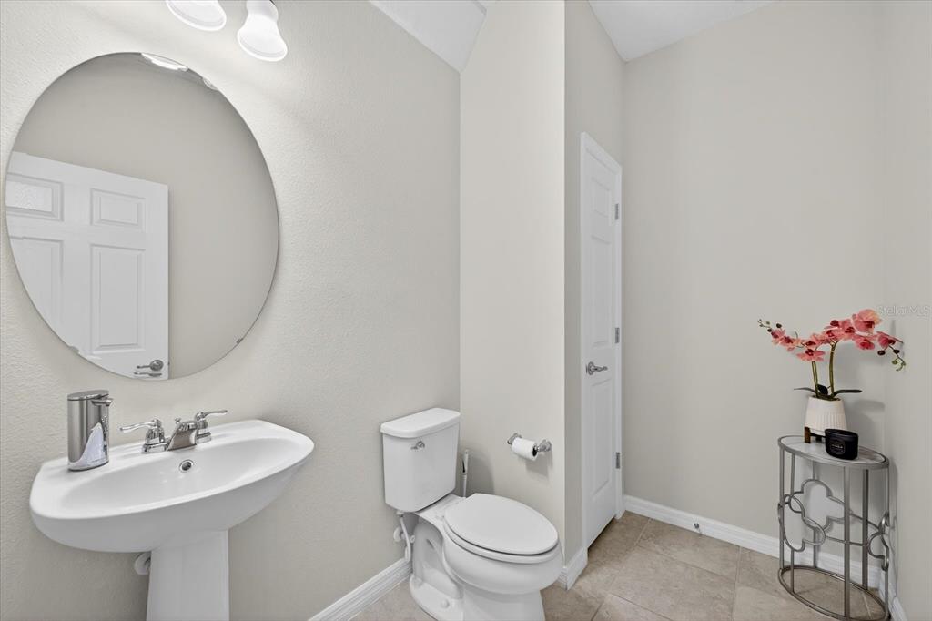 12740 Palapa Loop Spring Hill, FL 34610 - Photo 17 of 68 a bathroom with a sink mirror and toilet