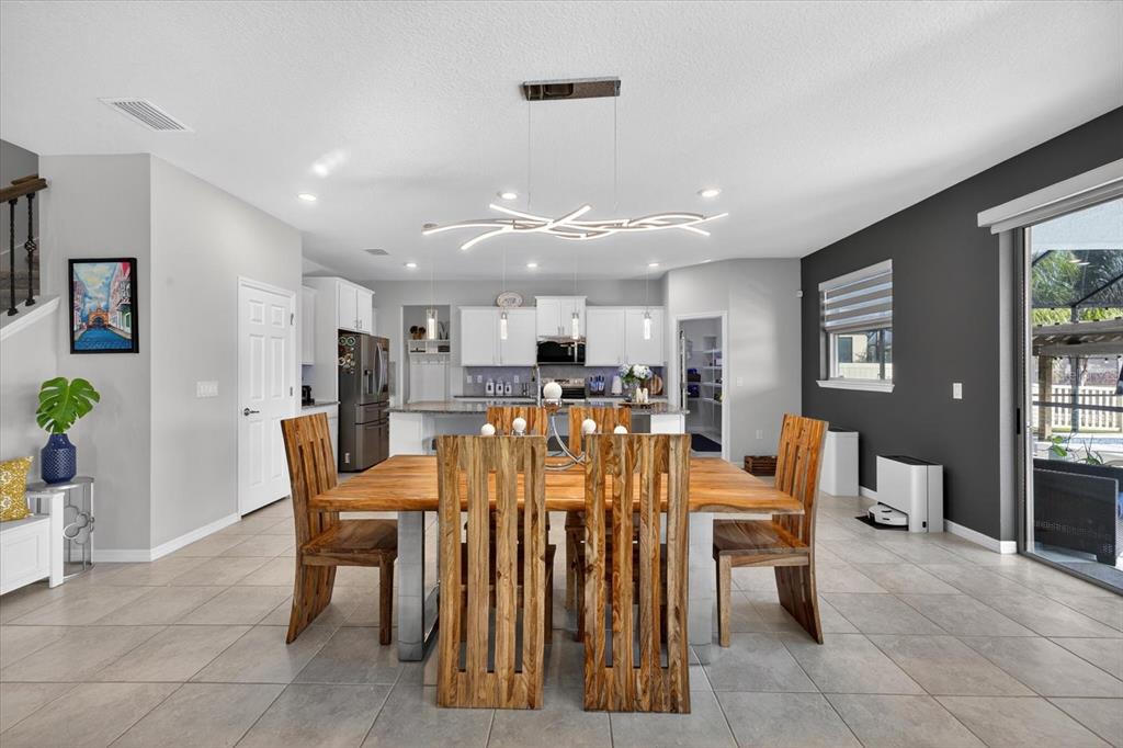 12740 Palapa Loop Spring Hill, FL 34610 - Photo 21 of 68 a view of a dining room with furniture