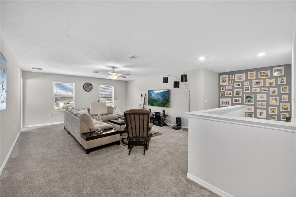 12740 Palapa Loop Spring Hill, FL 34610 - Photo 32 of 68 a living room with furniture and a large window