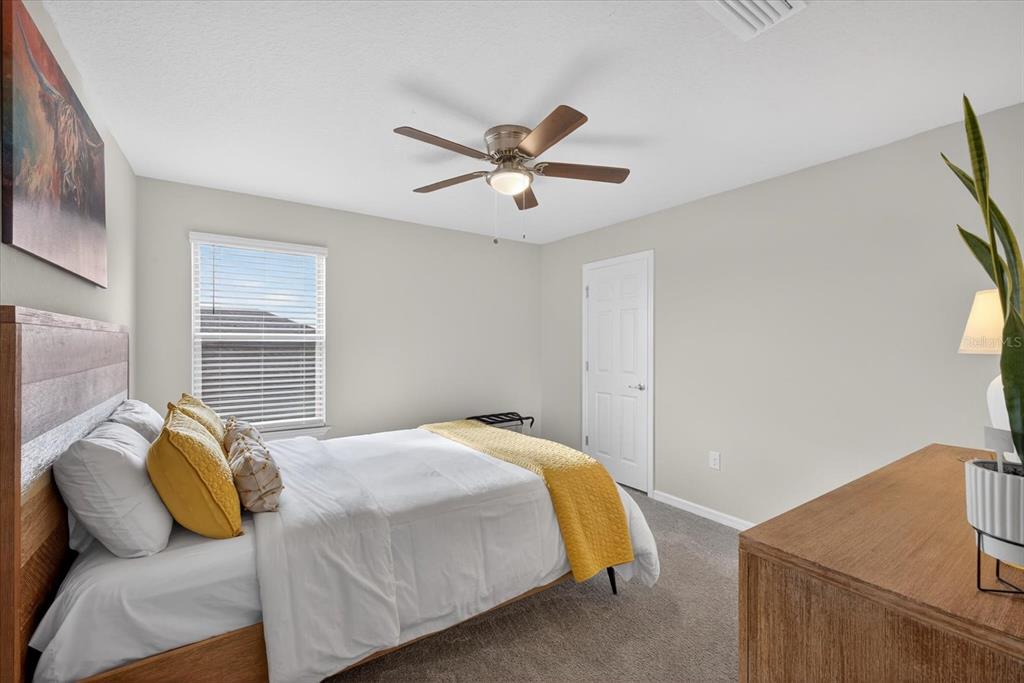 12740 Palapa Loop Spring Hill, FL 34610 - Photo 33 of 68 a bedroom with a bed and a window