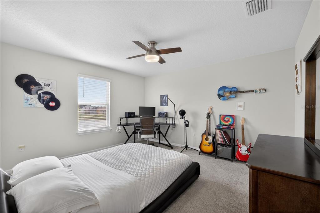 12740 Palapa Loop Spring Hill, FL 34610 - Photo 36 of 68 a bedroom with bed and a window