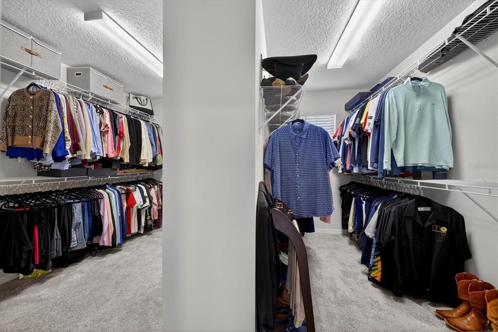 12740 Palapa Loop Spring Hill, FL 34610 - Photo 44 of 68 a view of walk in closet with clothes and shoes