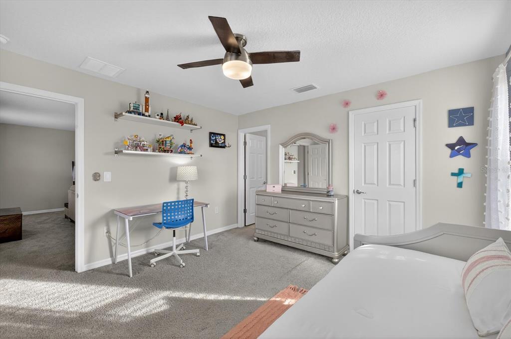 12740 Palapa Loop Spring Hill, FL 34610 - Photo 46 of 68 a bedroom with a bed and a cabinets