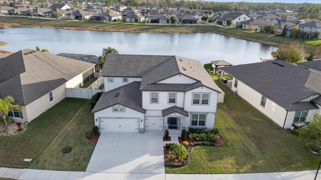 12740 Palapa Loop Spring Hill, FL 34610 - Photo 9 of 68 an aerial view of a house with a lake view