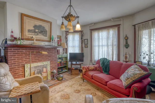 a open kitchen with stainless steel appliances granite countertop a stove a refrigerator a oven a dining table and chairs with wooden floor