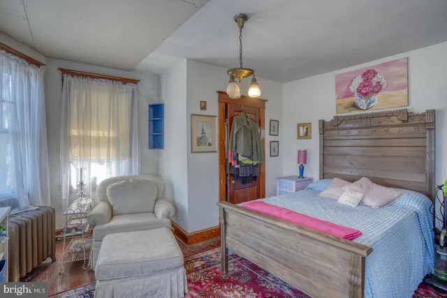 a bedroom with furniture and a book shelf
