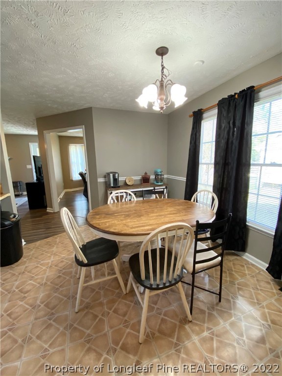 271 Stone Cross Drive Spring Lake, NC 28390 - Photo 13 of 38 a view of a dining room with furniture