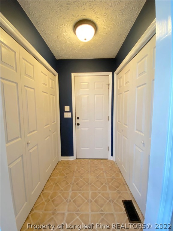 271 Stone Cross Drive Spring Lake, NC 28390 - Photo 16 of 38 a view of a big room with wooden floor and windows