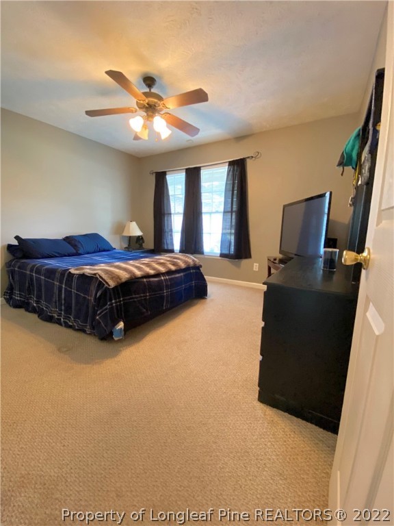 271 Stone Cross Drive Spring Lake, NC 28390 - Photo 20 of 38 a living room with a bed furniture and a large window
