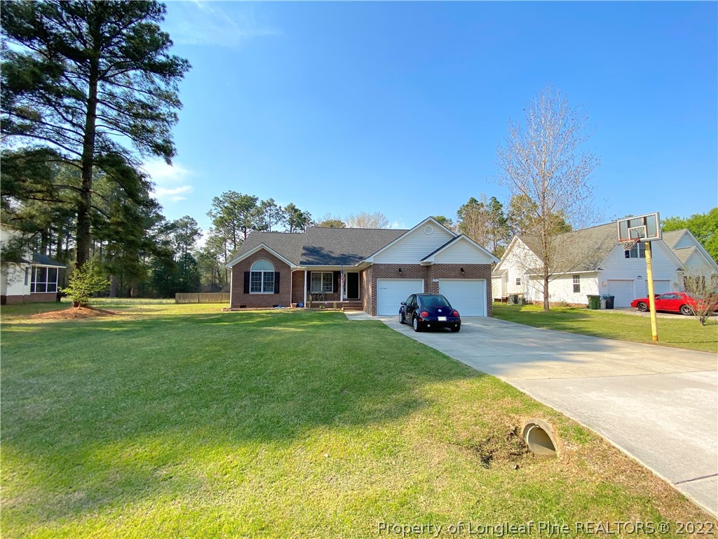 271 Stone Cross Drive Spring Lake, NC 28390 - Photo 2 of 38 a view of a house with a big yard and large trees