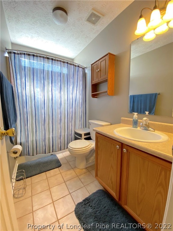271 Stone Cross Drive Spring Lake, NC 28390 - Photo 24 of 38 a bathroom with a sink a toilet and mirror