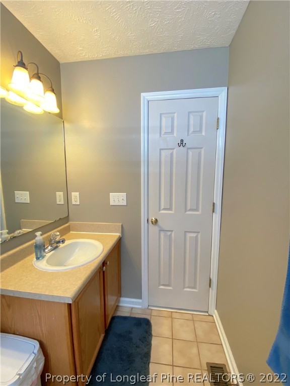271 Stone Cross Drive Spring Lake, NC 28390 - Photo 25 of 38 a bathroom with a sink a mirror and a shower