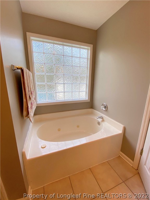 271 Stone Cross Drive Spring Lake, NC 28390 - Photo 30 of 38 a bath tub sitting in a bathroom next to a window