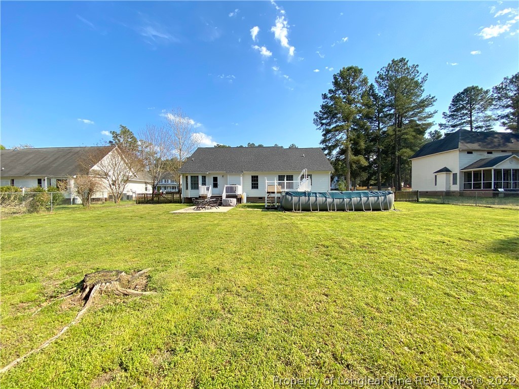 271 Stone Cross Drive Spring Lake, NC 28390 - Photo 35 of 38 a view of a swimming pool with an outdoor space and seating area