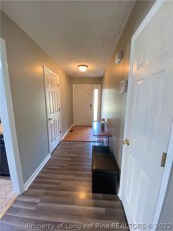 271 Stone Cross Drive Spring Lake, NC 28390 - Photo 5 of 38 a view of entryway and hall with wooden floor