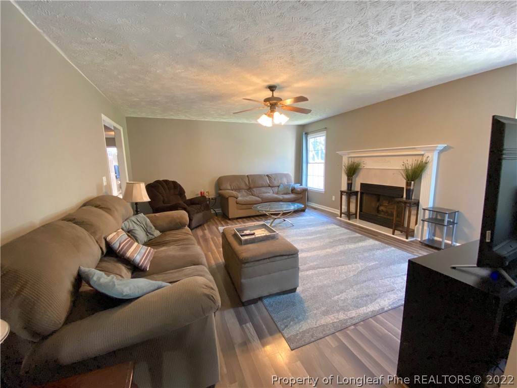 271 Stone Cross Drive Spring Lake, NC 28390 - Photo 8 of 38 a living room with furniture and a fireplace