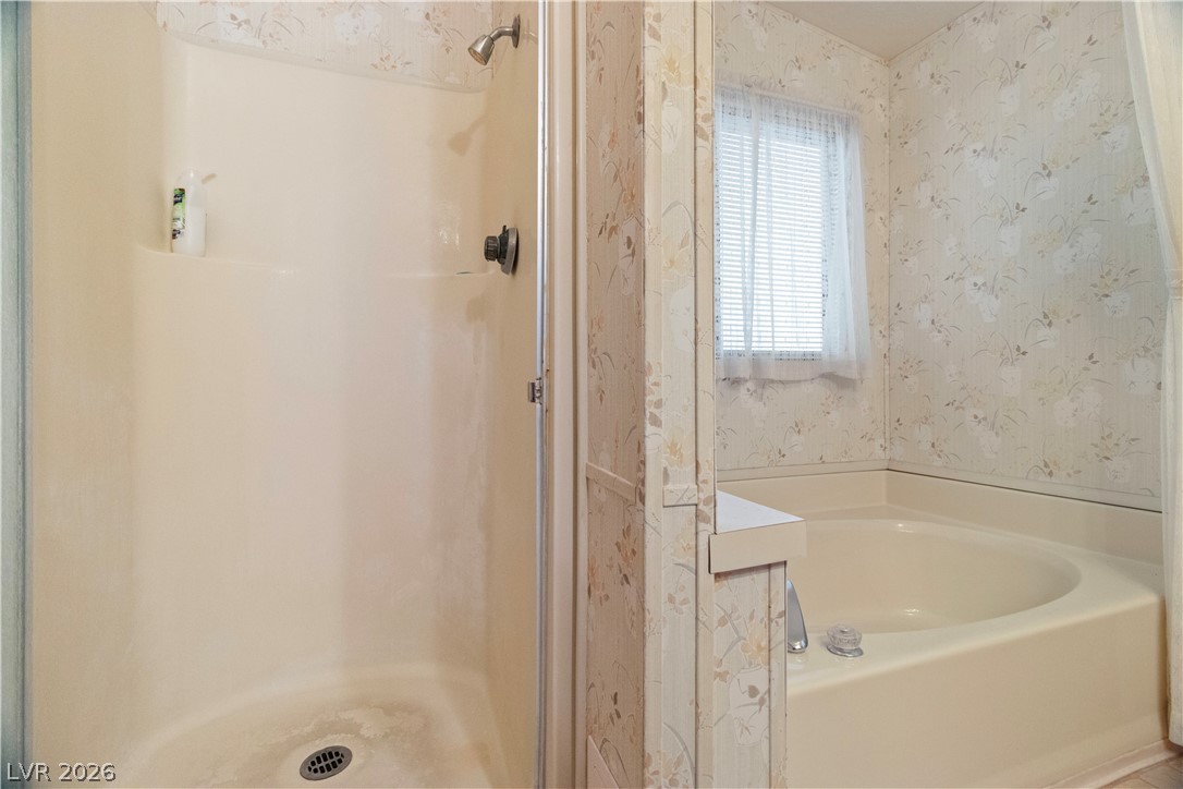 1609 Cajon Court Laughlin, NV 89029 - Photo 22 of 69 Full Primary bathroom featuring a garden tub, wallpapered walls, and a shower stall