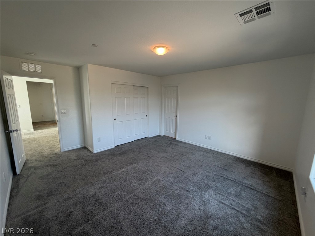 3228 Azalea Ridge Court Henderson, NV 89052 - Photo 14 of 28 A well-lit room showcasing plush carpet and convenient sliding closet doors.