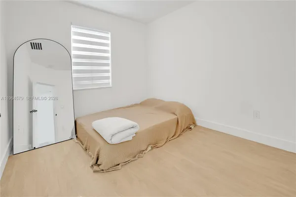 a bedroom with a bed and a window