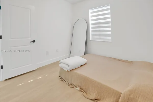 a bedroom with a bed and a window