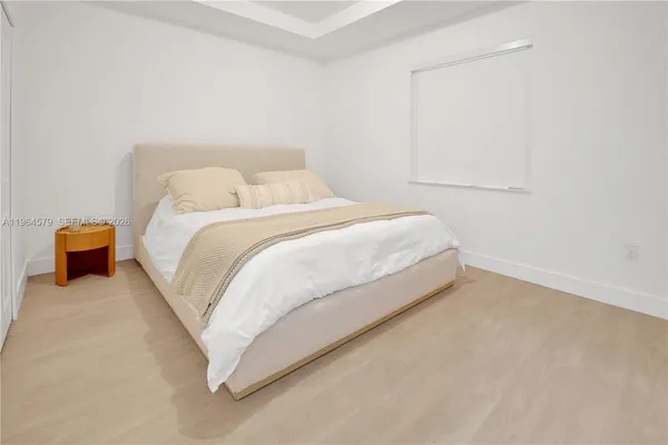 a bedroom with a bed and a lamp