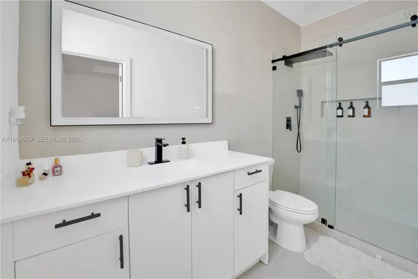 a bathroom with a sink toilet and shower