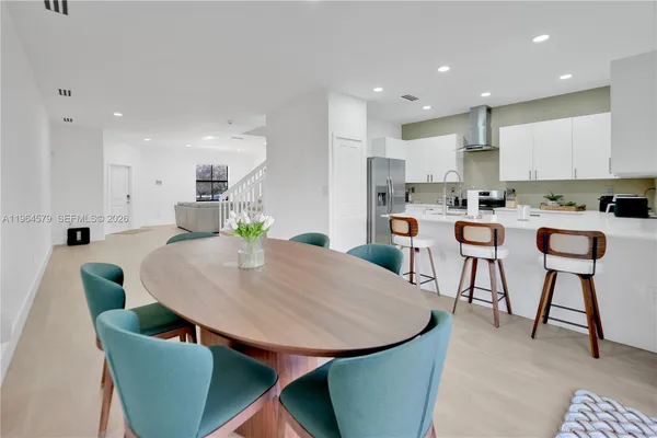 a living room with stainless steel appliances kitchen island granite countertop furniture and a kitchen view