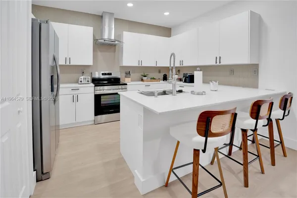 a kitchen with stainless steel appliances kitchen island granite countertop a sink and cabinets