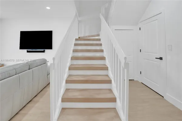 a view of entryway and hall with wooden floor