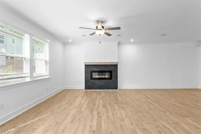 a view of an empty room with a fireplace and a window