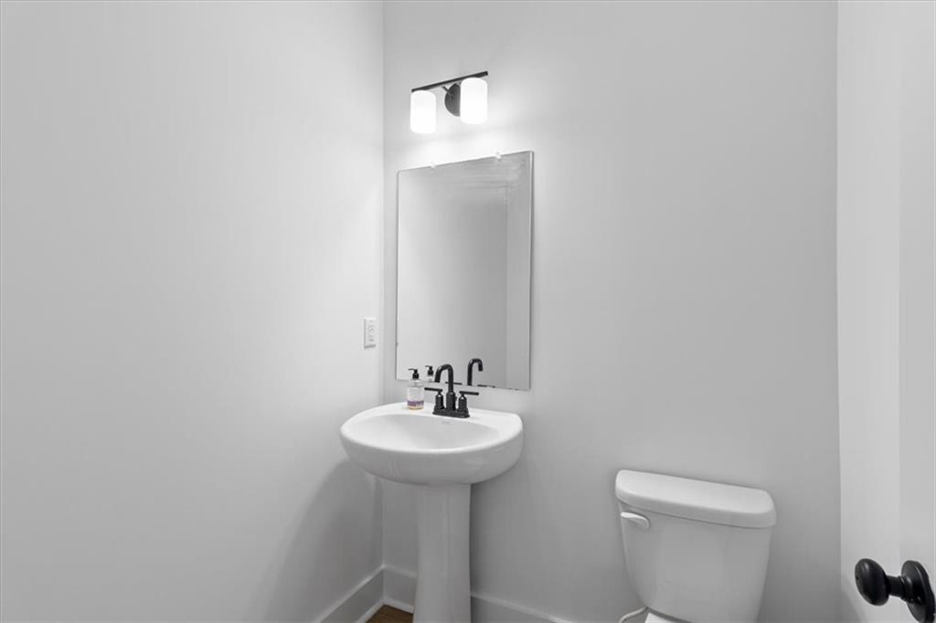 3376 Macaiva Alley Avondale Estates, GA 30002 - Photo 17 of 42 a bathroom with a sink a mirror and a toilet