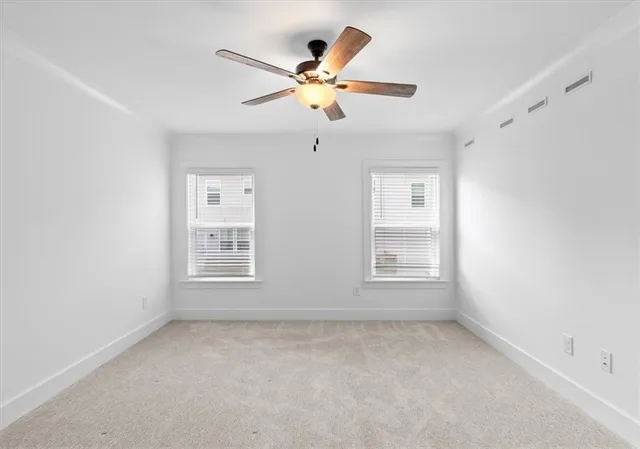 a view of empty room with ceiling fan
