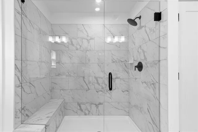 a spacious bathroom with a shower sink and mirror