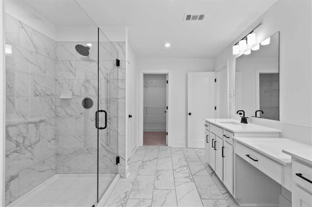 3376 Macaiva Alley Avondale Estates, GA 30002 - Photo 22 of 42 a spacious bathroom with a shower sink and mirror