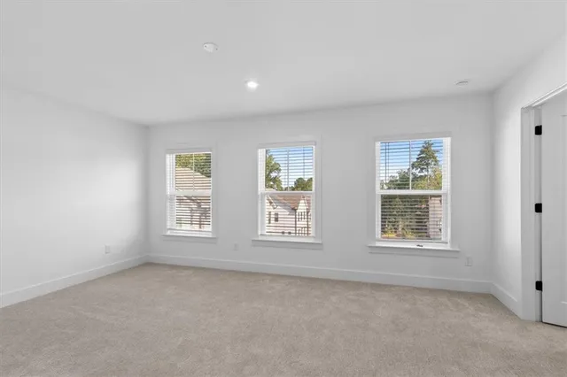 an empty room with closet and a window