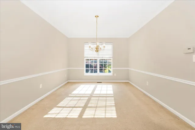 a large kitchen with kitchen island a large window a sink and stainless steel appliances