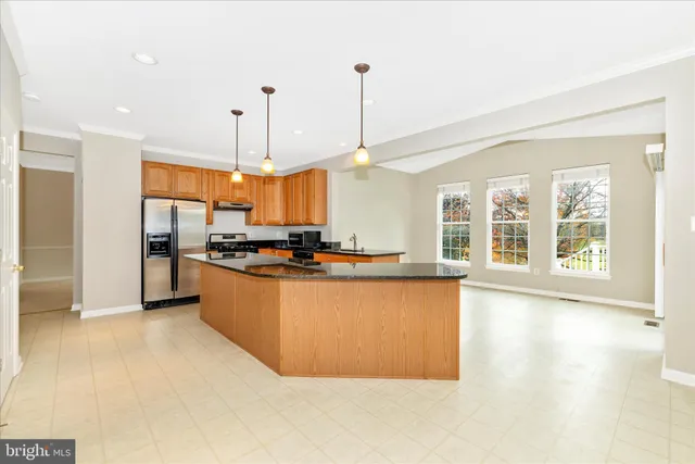 a kitchen with stainless steel appliances granite countertop a sink and a granite counter tops