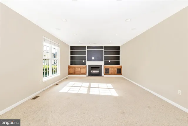 an empty room with furniture and a window