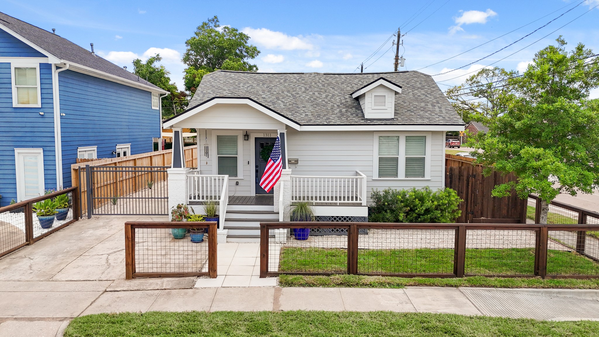Located in the Heights, this charming bungalow with craftsman-style details could be your next residence or the perfect spot for an office. With a new roof installed in 2024, the exterior has a mix of wood and metal fencing surrounding the front yard, recent landscaping and a private driveway gate leads to the backyard.