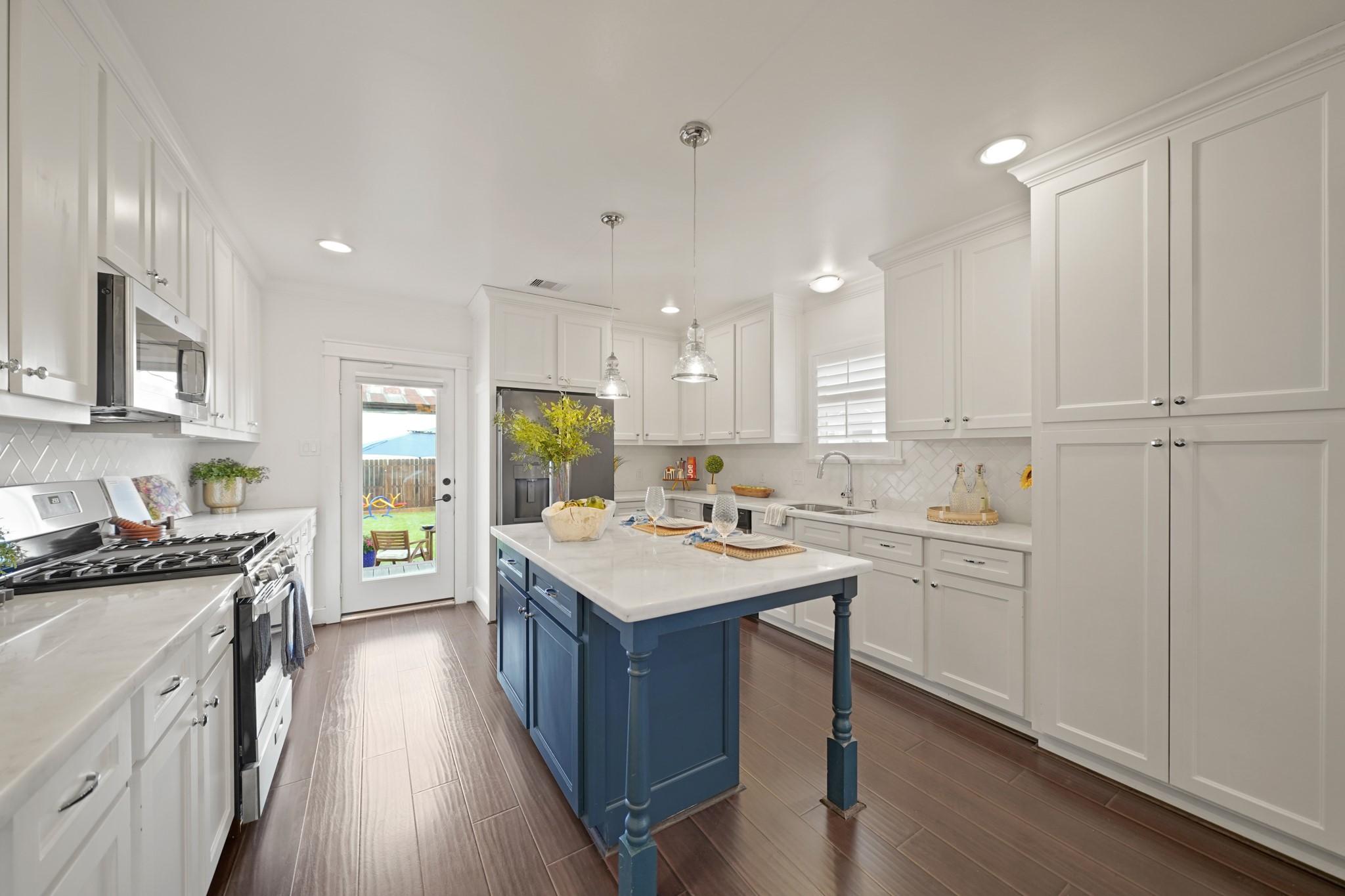 1311 Walton Street Houston, TX 77009 - Photo 14 of 43 The center island includes a breakfast bar and built-in storage, perfect for prepping meals or enjoying a quick bite. Custom pantry-depth cabinets provide additional storage and easy access to all your kitchen essentials.
