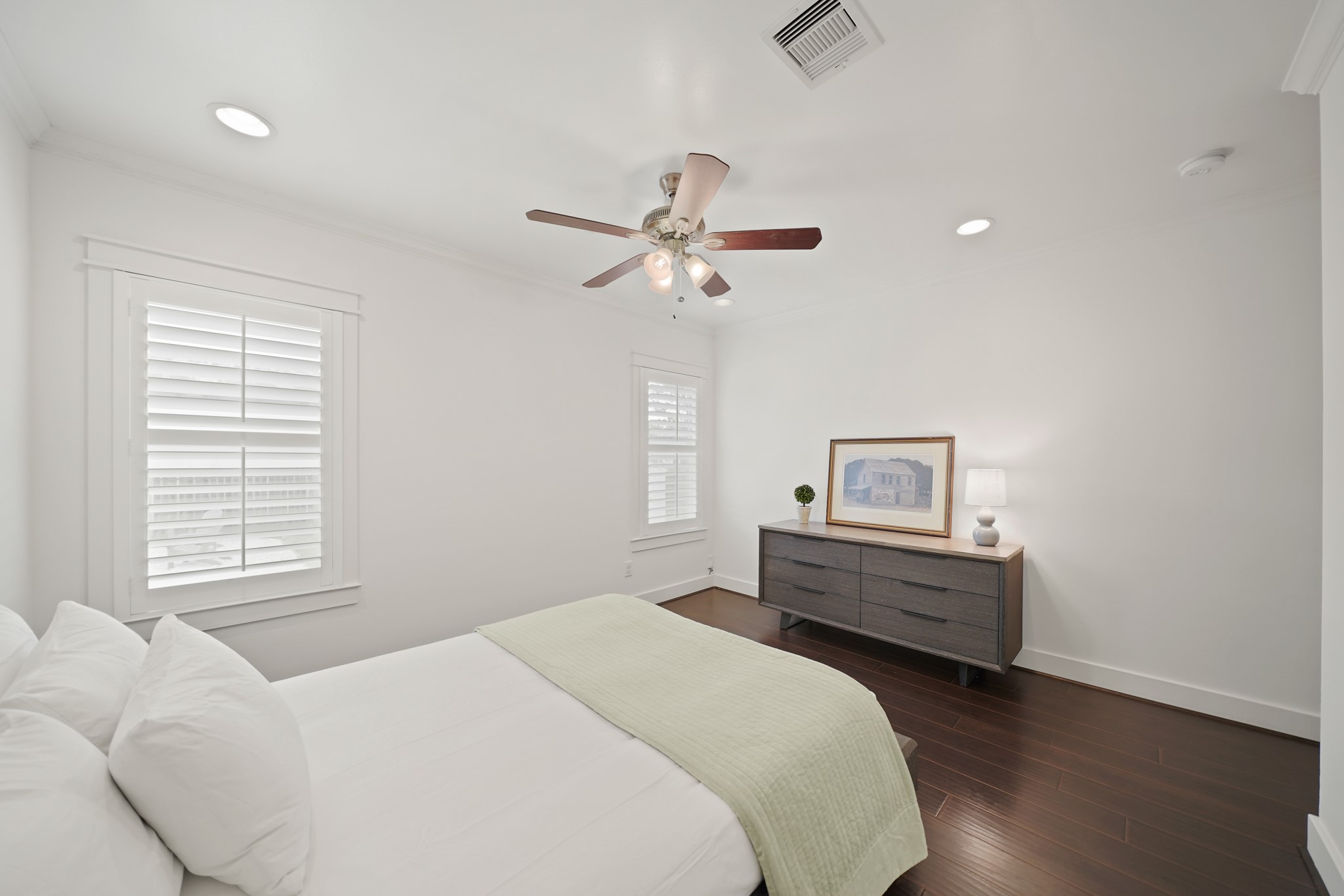 1311 Walton Street Houston, TX 77009 - Photo 20 of 43 Windows with plantation shutters offer backyard views and soft natural light. The room also includes recessed lighting and a ceiling fan with light above to complete the relaxing atmosphere.