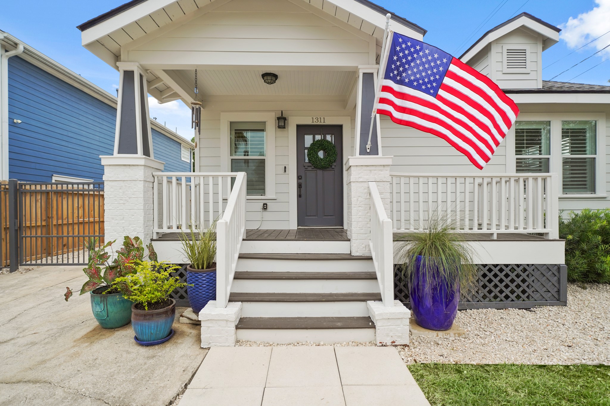 1311 Walton Street Houston, TX 77009 - Photo 2 of 43 The 17’ x 7’ covered front porch is a peaceful spot to enjoy a quiet morning or unwind after a long day. With its extended layout, classic brick and wood columns and a beautiful mission-style wood door, it offers timeless charm. A bronzed coach lantern gives the space a warm, cozy glow that makes it feel like home.