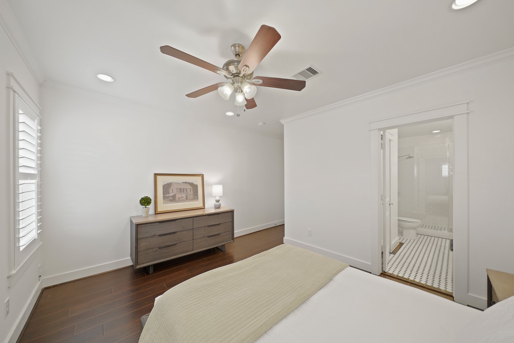 1311 Walton Street Houston, TX 77009 - Photo 21 of 43 The updated primary bath is just steps away through a private entry from the bedroom on the right.