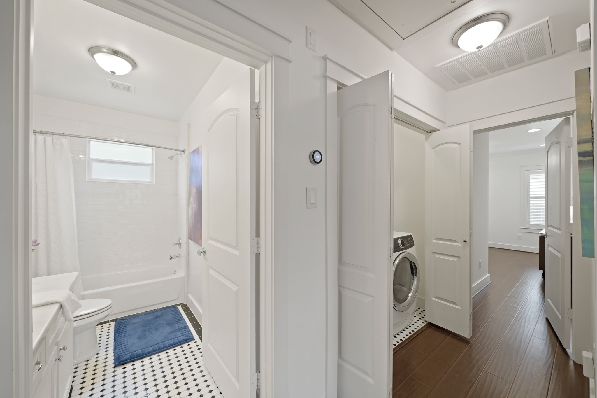 1311 Walton Street Houston, TX 77009 - Photo 27 of 43 From the hallway, you’ll find easy access to the second bathroom, laundry room, and primary suite, keeping everything close, yet comfortably spaced.