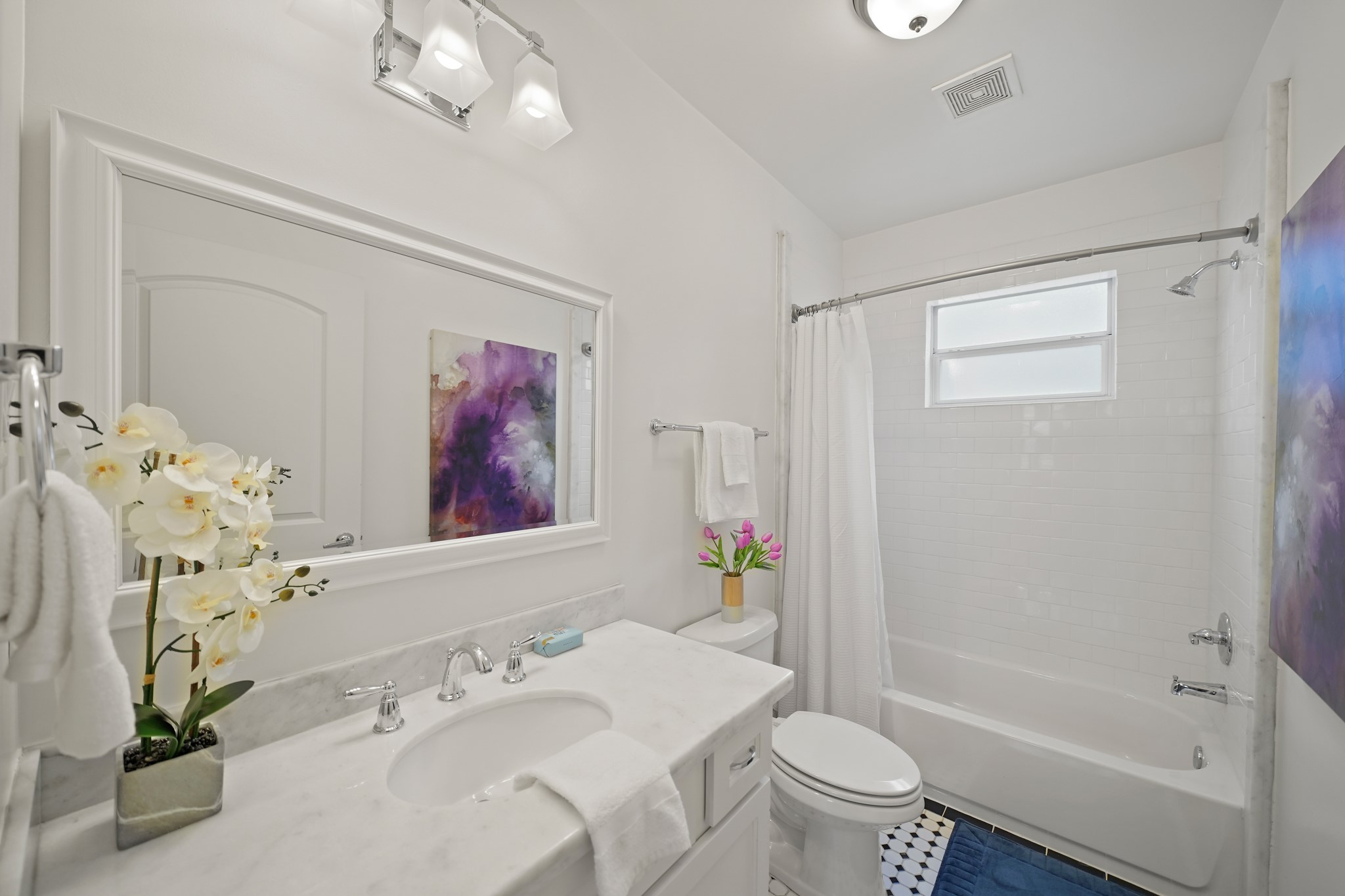 1311 Walton Street Houston, TX 77009 - Photo 28 of 43 The second bathroom includes decorative tile flooring, a marble countertop with cabinetry below and a framed mirror with lighting above.