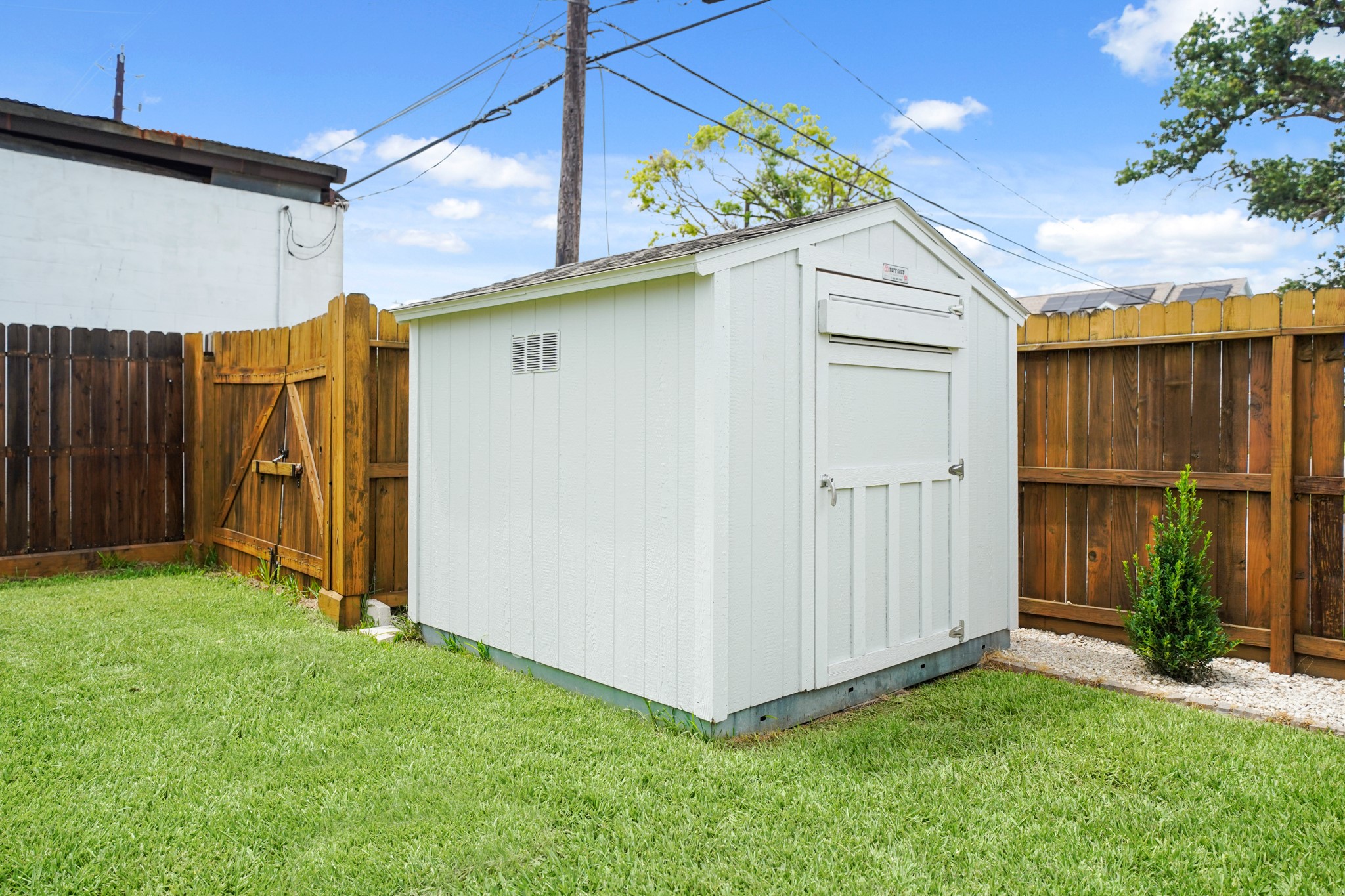 1311 Walton Street Houston, TX 77009 - Photo 36 of 43 A dedicated storage shed stays with home and sits neatly in the backyard, offering the perfect spot to tuck away tools, outdoor supplies, or hobby equipment.