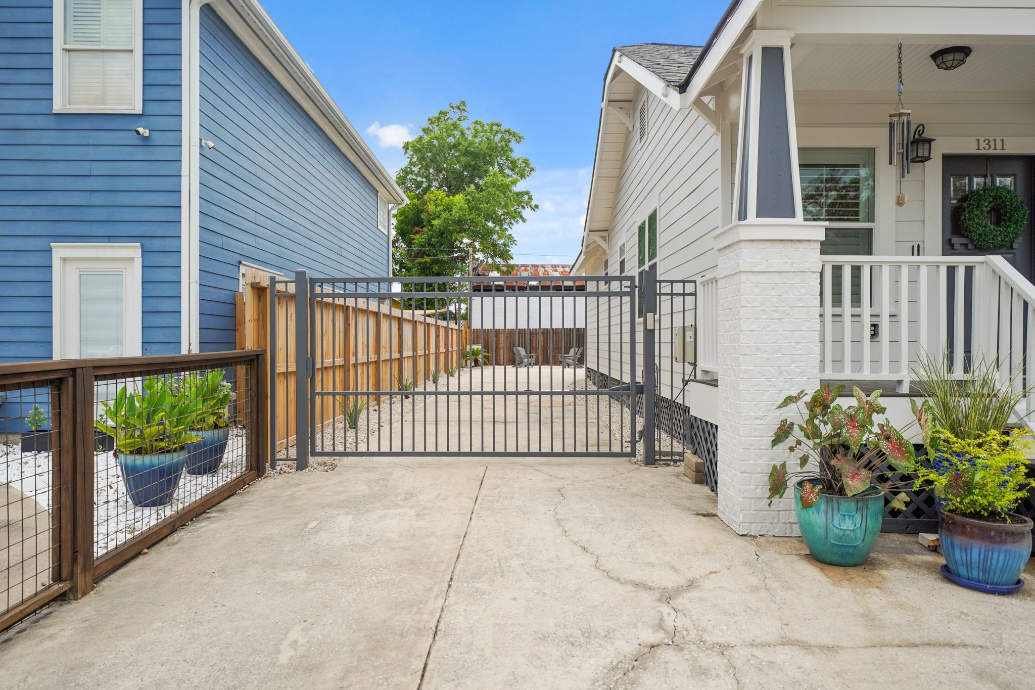 1311 Walton Street Houston, TX 77009 - Photo 42 of 43 The driveway gate adds a clean, finished touch, leading to extra parking and the private back patio area.