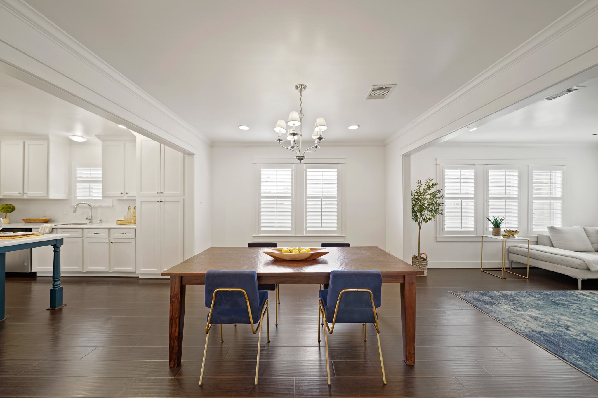 1311 Walton Street Houston, TX 77009 - Photo 10 of 43 The dining area features beautiful hardwood floors, crown moulding and a classic chandelier with shades that creates a bright and airy space to enjoy meals.